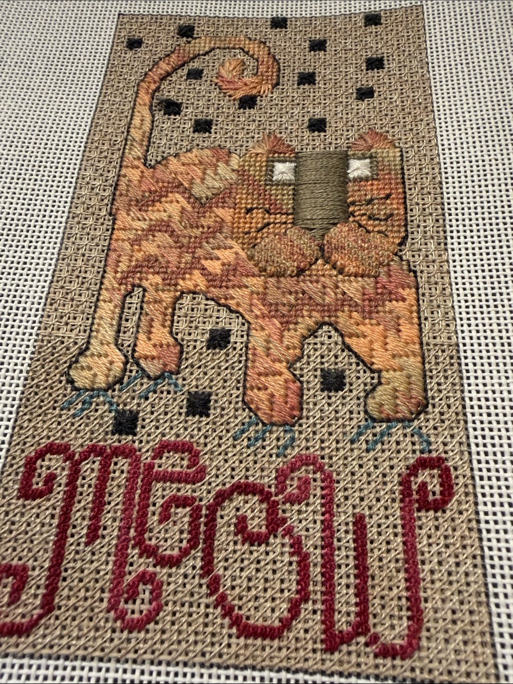 needlepoint canvas featuring a stylized cat and the word "Meow". 🐈‍⬛